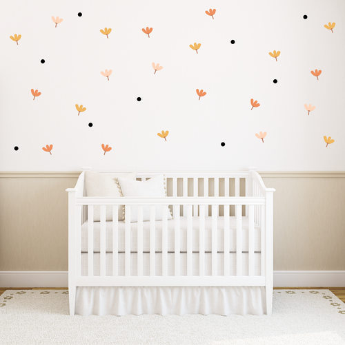 Blossom Confetti flower and dot wall decals arranged on a white nursery wall in soft peach and terracotta tones.