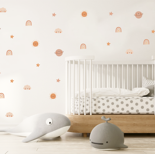 cosmic cuties wall stickers arranged above a baby crib in a neutral nursery