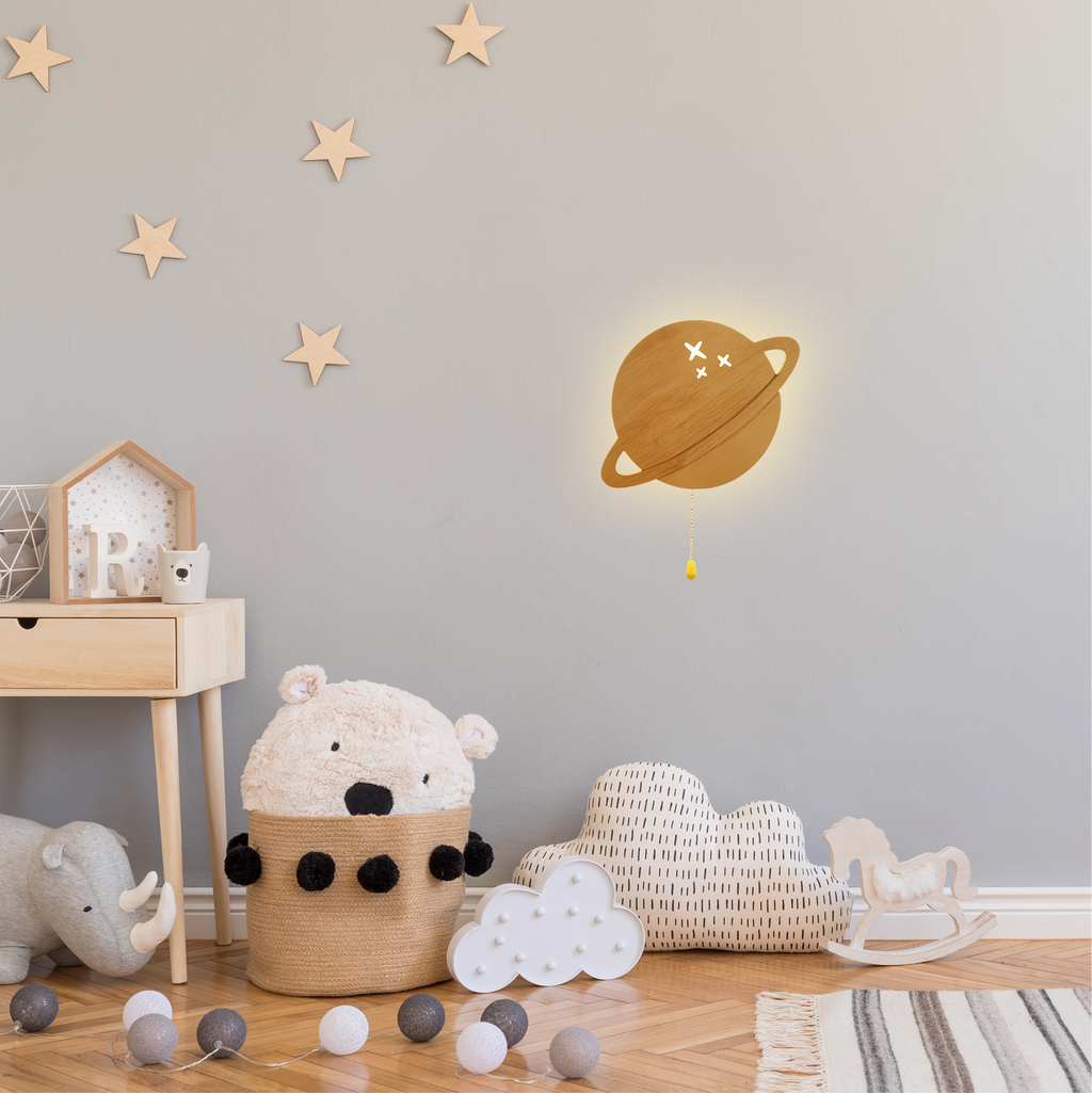 Warm LED planet wall lamp mounted in a cozy nursery with soft neutral decor and star accents