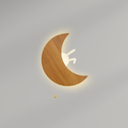 Close-up of wooden crescent moon wall lamp featuring a small bunny and warm ambient LED light