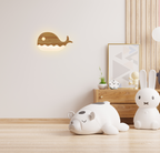 Warm LED whale wall lamp adding soft ambient light to a modern children’s bedroom